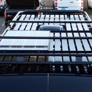 Upfitted cargo van featuring Zamp solar panel on Rhino roof rack.