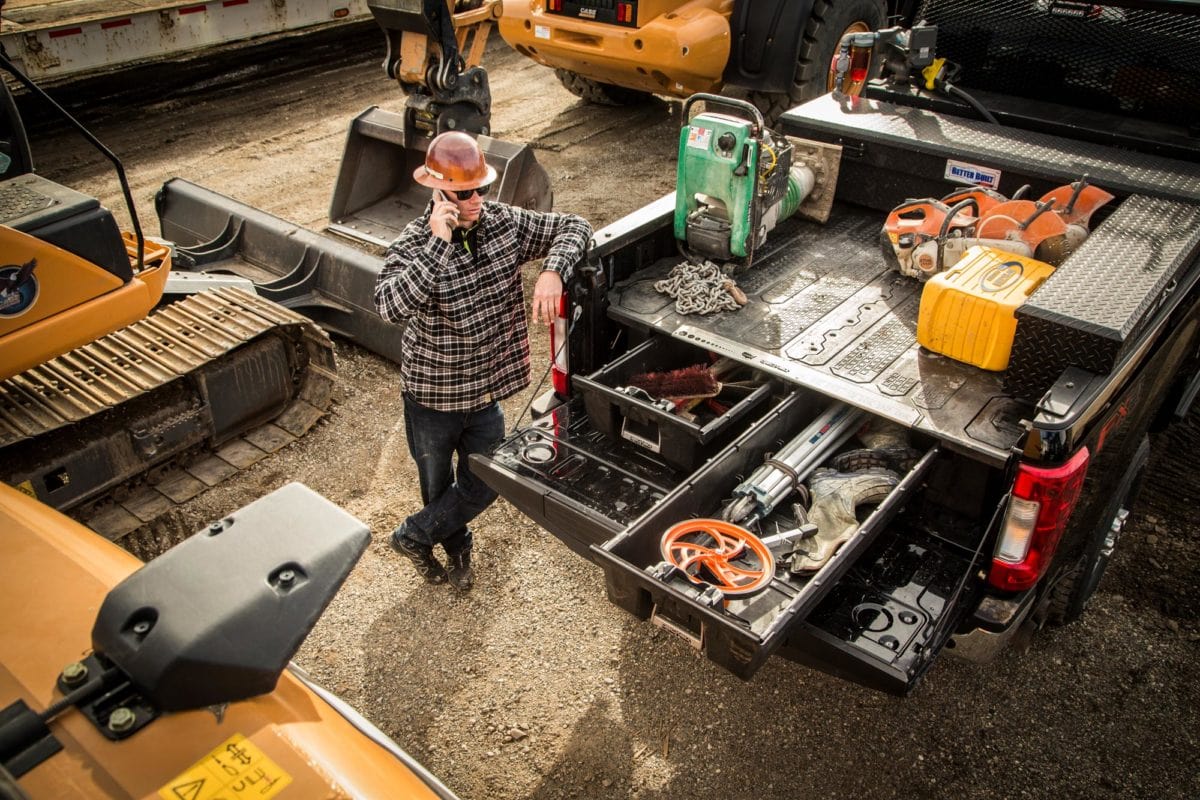 Equipment at construction site on DECKED CargoGlide slide with other gear organized in DECKED drawers.