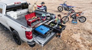 Truck with DECKED CargoGlide Truck Bed System and Drawer System at dirtbike staging area.