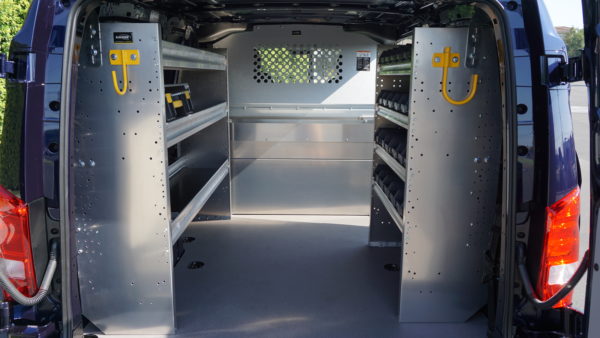 Customized van interior with Ranger shelving system, hang hooks, and bulkhead protection — example of our Work Trucks and Vans solutions.