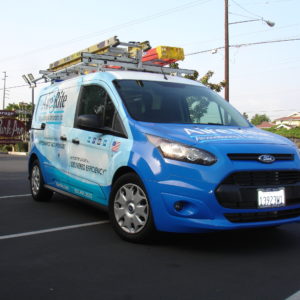 HVAC service van with branded vehicle wrap and Prime Design ladder rack.