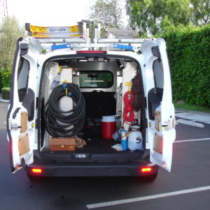 Upfitted pest control van with Legend Paneling, Prime Design ErgoRack, Ranger shelving, and gear hooks.