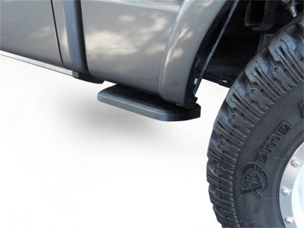 AMP Research BedStep mounted between the cab and rear tire, in the hidden up position.