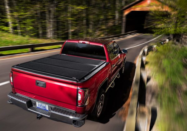 Red GMC Truck on Road with Extang Bed Cover