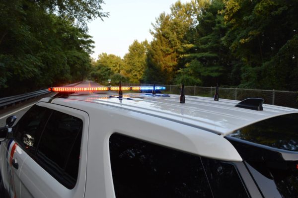 Police Cruiser Blocking a Street with Whelen Warning Lights Flashing.