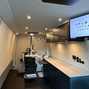 Mobile eye clinic van featuring shelving for cargo van, cabinetry, and custom exam chair.
