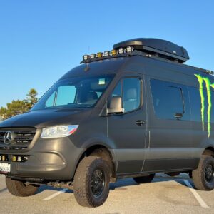 Work Trucks and Vans example: Monster-branded Mercedes van with LED light bar and rooftop gear carrier.