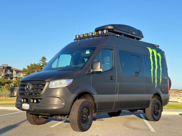 Work Trucks and Vans example: Monster-branded Mercedes van with LED light bar and rooftop gear carrier.