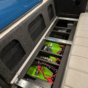 Power pack stowed beneath seating in customized van by American Trucks and Vans.