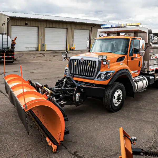 Service Dump Truck with Plow Outfitted with When Emergency Warning Lights