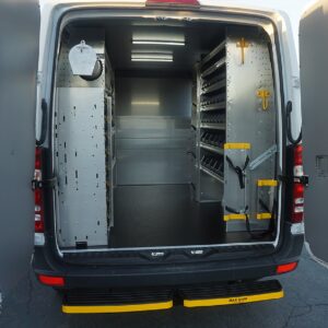 PlumbingVan Interior Upfit with Shelving, Hooks, Flooring, Bulkhead, and Pipe Tube.