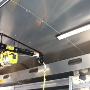 Close-up of 350 lb capacity winch with finished metal ceiling and bright overhead lighting inside plumbing van