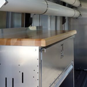 Close-up of workbench and cabinet inside plumbing van.