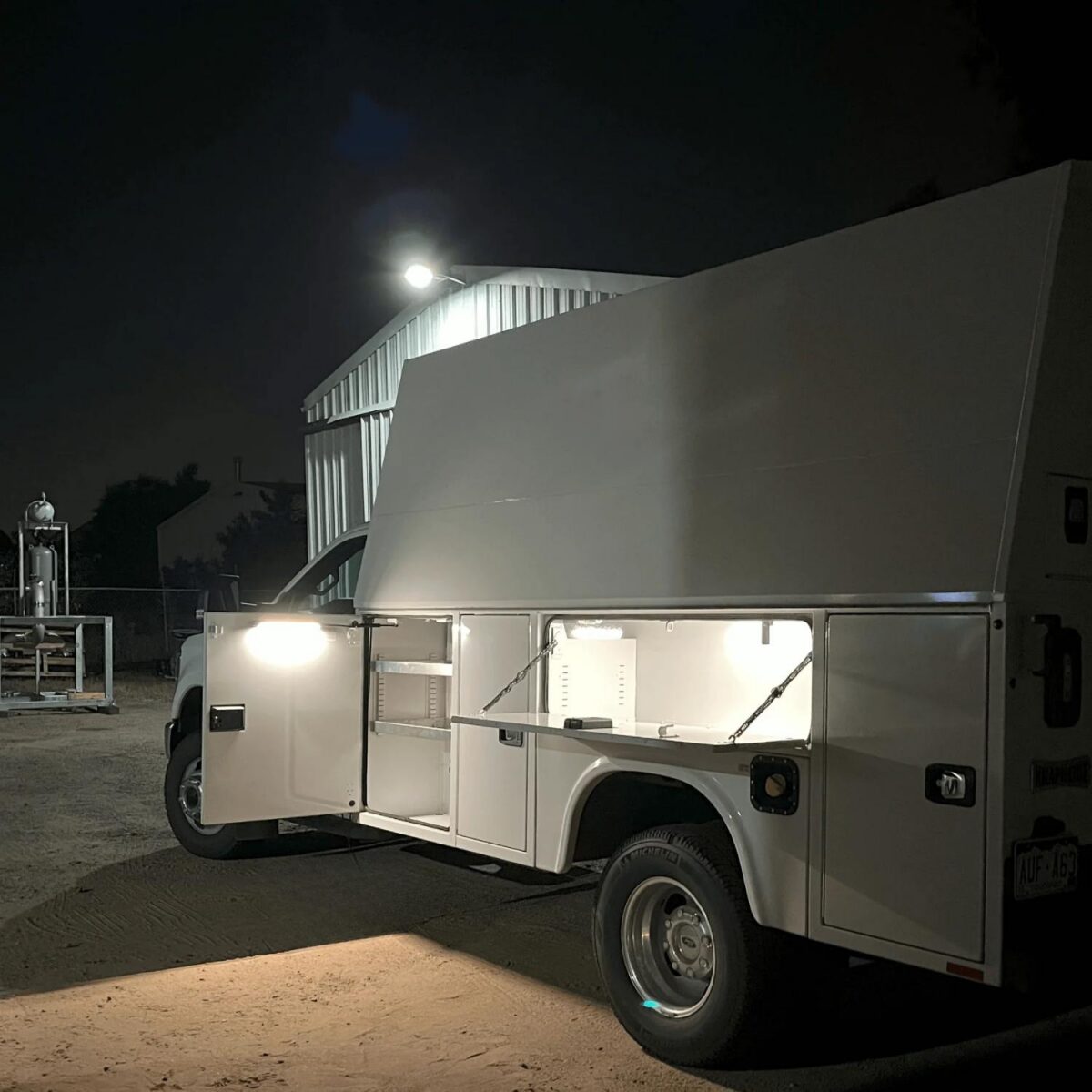 Kingpin lighting mount on commercial vehicle to illuminate exterior cabinets.