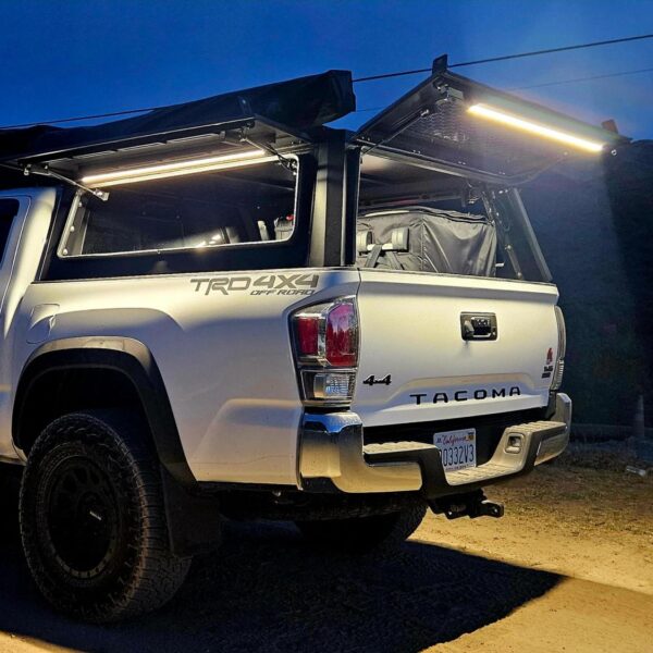 Kingpin Lighting illuminating open camper shell from rear and side access