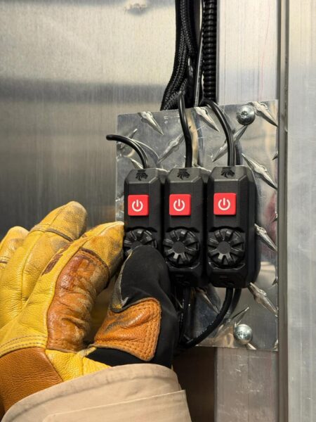Kingpin Lighting switches mounted on diamond plate with gloved hand operation