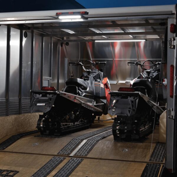 Kingpin Lighting illuminating trailer with snowmobiles for early morning prep