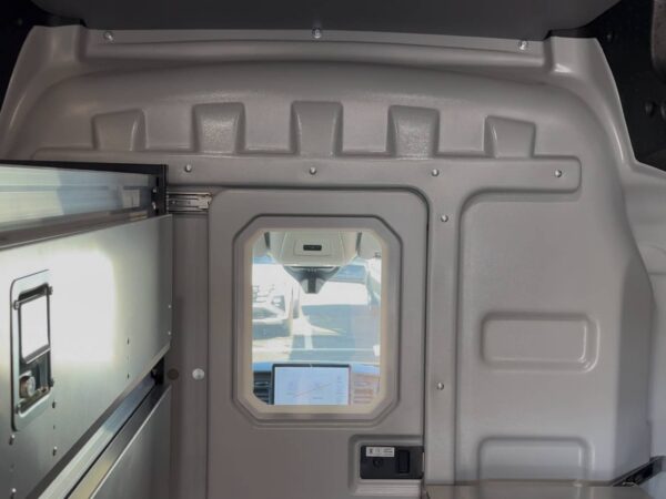 Sortimo ProPartition Light van partition with sliding door and viewing window separating the cab from the cargo area.